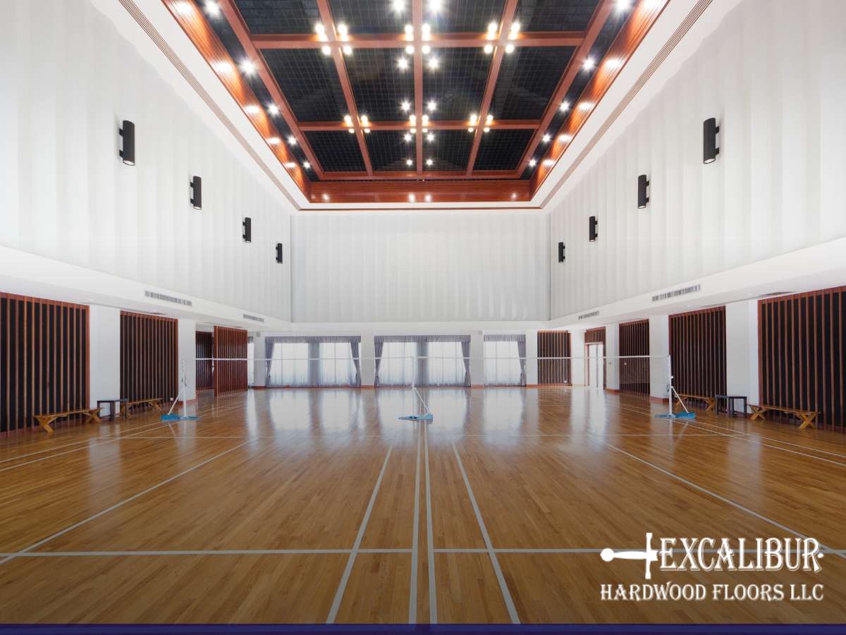 Polished hardwood gym floor with sports markings, illustrating its maintenance needs for lasting use.