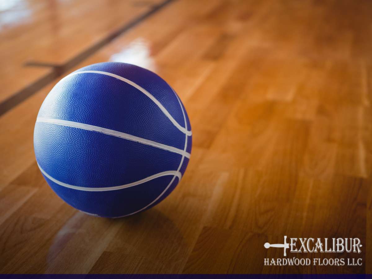 Blue basketball on a polished School Gym Floor.